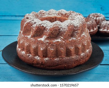 Homemade Chestnut Bundt Cake, Dusted With Sugar,  On Blue Wooden Background