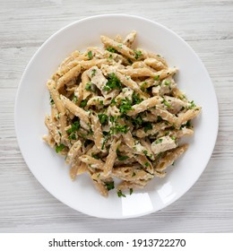 Homemade Chicken Alfredo Penne With Parsley On A White Wooden Table, Top View. Overhead, From Above, Flat Lay. 