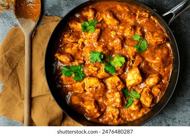 homemade Chicken curry in pan with wooden spoon - Powered by Shutterstock