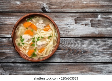 Homemade Chicken Noodle Soup On A Wooden Old Background. View From Above.