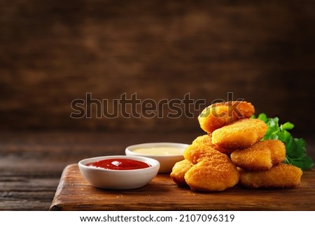 Homemade chicken nuggets and sauces with copy space