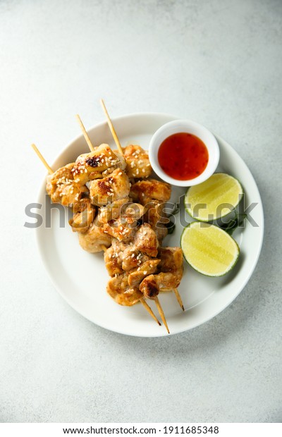 Homemade\
chicken skewers with chili sauce and\
lime