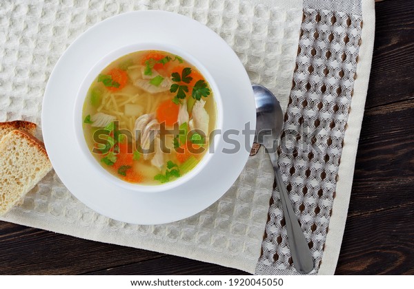 Homemade chicken\
soup with vegetables and\
noodles