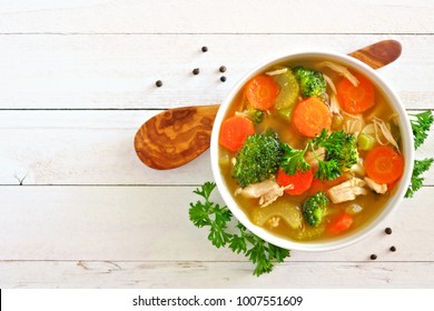 Homemade chicken vegetable soup, overhead view on a white wood background - Powered by Shutterstock