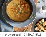 Homemade chickpea soup in a bowl with croutons. Winter dish. Healthy and vegetarian food. Directly above.