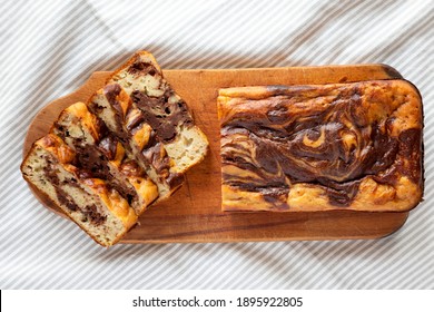 Homemade Chocolate Banana Bread On A Rustic Wooden Board On A White Wooden Background, Top View. Flat Lay, Overhead, From Above. 