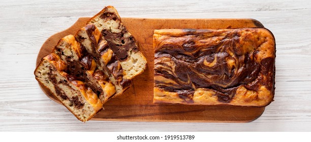 Homemade Chocolate Banana Bread On A Rustic Wooden Board On A White Wooden Background, Top View. Flat Lay, Overhead, From Above. 