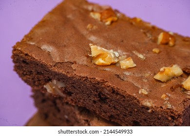 Homemade Chocolate Brownie Squares With Pecan Pieces. Orange Background. Natural, Healthy Food Concept. High View.