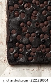 Homemade Chocolate Brownies With Dark Chocolate On A Baking Paper, Isolated On A White. Overhead View.