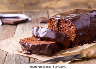 Homemade chocolate cake on baking paper, rustic style