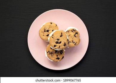 Homemade Chocolate Chip Cookie Ice Cream Sandwich On A Pink Plate On A Black Surface, Top View. Overhead, From Above, Flat Lay.