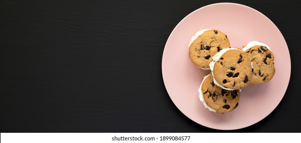 Homemade Chocolate Chip Cookie Ice Cream Sandwich On A Pink Plate On A Black Surface, Top View. Overhead, From Above, Flat Lay.