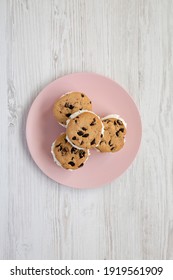 Homemade Chocolate Chip Cookie Ice Cream Sandwich On A Pink Plate On A White Wooden Table, Top View. Overhead, From Above, Flat Lay. 