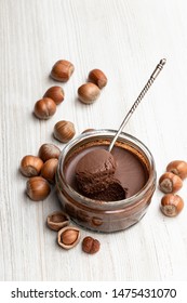 Homemade  Chocolate Hazelnut Praline In Glass Jar On White Wooden Table  