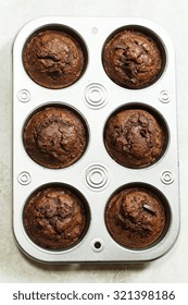 Homemade Chocolate Muffins On Muffin Pan Overhead View