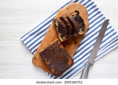 Homemade Chocolate And Vanilla Marble Cake On A Rustic Wooden Board, Top View. Flat Lay, Overhead, From Above. Copy Space.