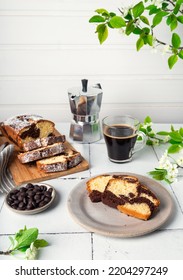 Homemade Chocolate Vanilla Marble Pound Cake With Cup Of Coffee And Cherry Blossoms On White Tile Background. 