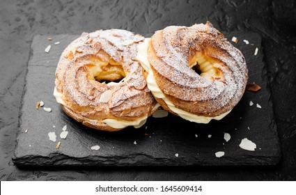 Homemade Choux Pastry Cake Paris Brest With Almond Flakes And Sugar Powder.