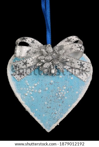Homemade Christmas tree decoration heart  made of wood, plaster and glitter  bow  isolated on black