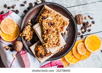 Homemade Citrus Granola Protein Bars With Peanut Butter, Honey, Oatmeal On Wooden Background