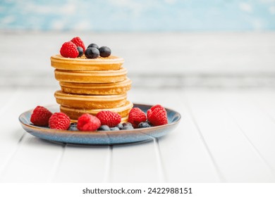 The homemade classic american pancakes with blueberries, raspberries and strawberries. - Powered by Shutterstock