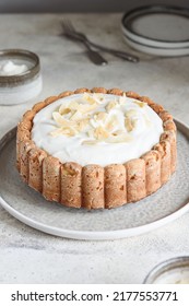 Homemade Coconut Buttermilk Pound Cake Glazed Whipped Cream And Coconut Flakes On Gray Concrete Background. Selective Focus