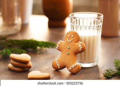 Homemade Cookies For The Feast Of Santa Claus . Glass Of Milk And Gingerbread Man Waiting For Christmas Night. Sweets, Xmas, New Year Concept