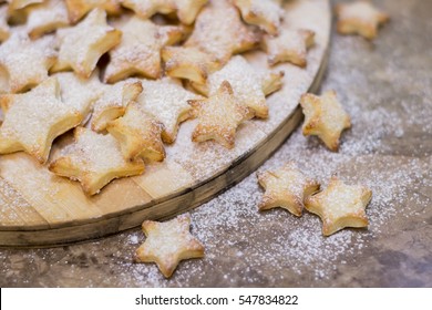 Homemade cookies shaped stars on wooden board, selective focus - Powered by Shutterstock