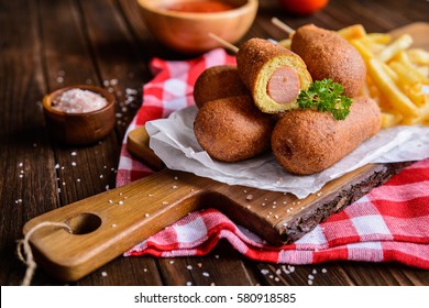 Homemade corn dogs with fries, ketchup and mustard - Powered by Shutterstock