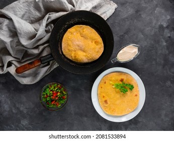 Homemade Corn Flatbread On Frying Pan Cilantro Green Tomato Salsa Linen Cloth. Handmade Mexican Tortilla Vegetable. Traditional Indian Makki Ki Roti Bread Top View. Wheat Flour Dough Authentic Cuisine