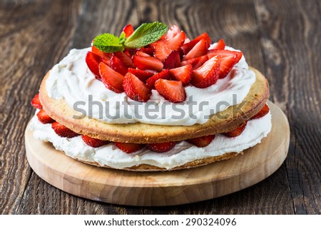 Homemade cream layer cake, fresh, colorful, and delicious dessert with juicy strawberries,  sweet whipped cream and cream cheese