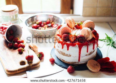 Homemade cream layer cake, fresh, colorful, and delicious dessert with juicy strawberries, sweet whipped cream, cream cheese and macaroons