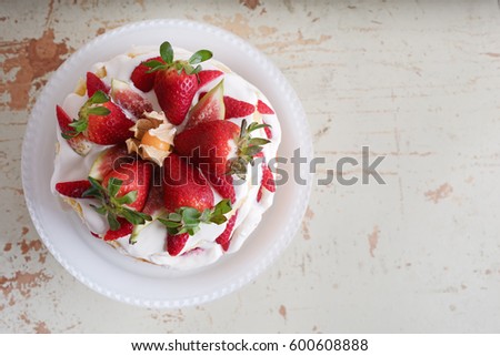 Homemade cream layer cake, fresh, colorful, and delicious dessert with juicy strawberries, sweet whipped cream and cream cheese. Selective focus. Space for text, wooden background.