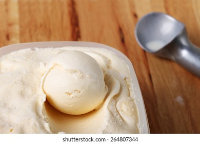 Homemade Creamy Vanilla Ice Cream Scoop In A White Cup Container With Metal Special Spoon 