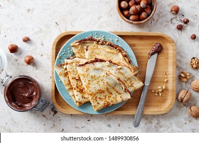 Homemade crepes, tasty thin pancakes with chocolate and nuts. 