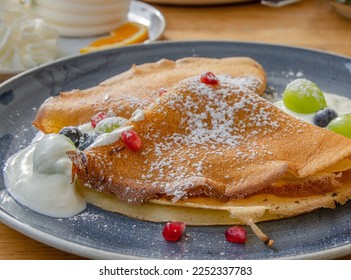 Homemade crepes, tasty thin pancakes with cottage cheese and berries. - Shutterstock ID 2252337783