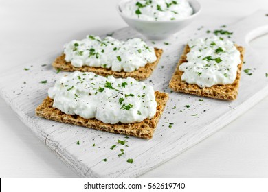 Homemade Crispbread toast with Cottage Cheese and parsley on white wooden board - Powered by Shutterstock