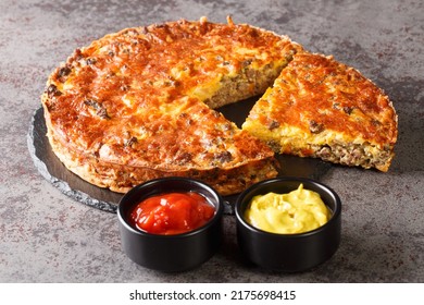 Homemade Crispy Cheeseburger Pie Served With Sauces Close-up On A Slate Board On The Table. Horizontal
