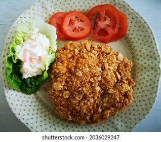 Homemade Crispy Corn Flakes Chicken With Tomatoes And Salad.