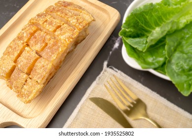 Homemade Crispy Pork Belly Or Deep Fried Pork In Whole, Made By Using Air Fryer, Serving On Wooden Tray With Fresh Vegetables