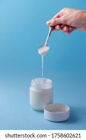 Homemade Crockpot Greek Yogurt In Glass Jars On Light Blue Background.