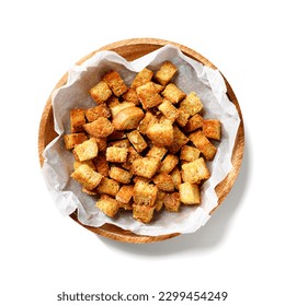 Homemade crunchy croutons flavored with parmesan cheese isolated on white background, top view