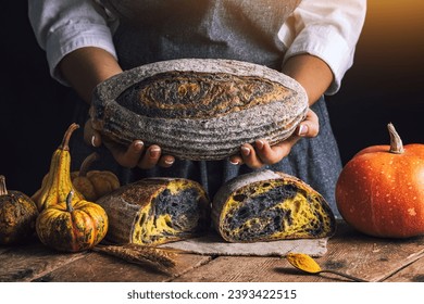 Homemade crusty sourdough bread oven baked and woman baker with autumn foods in kitchen - Powered by Shutterstock