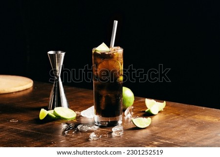 Homemade Cuba Libre cocktail booze rum, coke and lime wheel