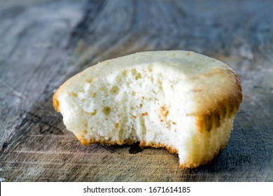 Homemade Cupcake Lies On A Wooden Cutting Board, Close-up, Bite Mark