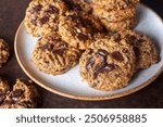 homemade dark chocolate chunk oatmeal cookies in ceramic plate.