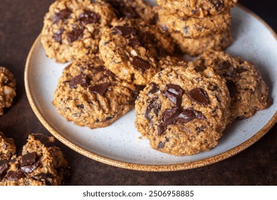 homemade dark chocolate chunk oatmeal cookies in ceramic plate.