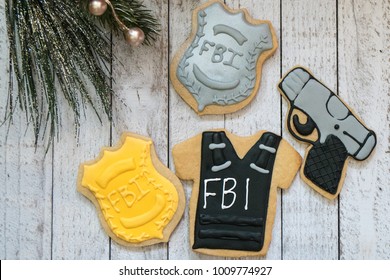 Homemade Decorated Sugar Cookies With An FBI (Federal Bureau Of Investigation) Theme With Bullet Proof Vest, Badge And Gun   