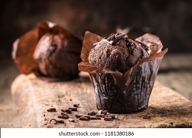 Homemade delicious chocolate muffin on wooden background close-up - Powered by Shutterstock