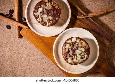Homemade delicious fresh chocolate and almonds cake on wooden table